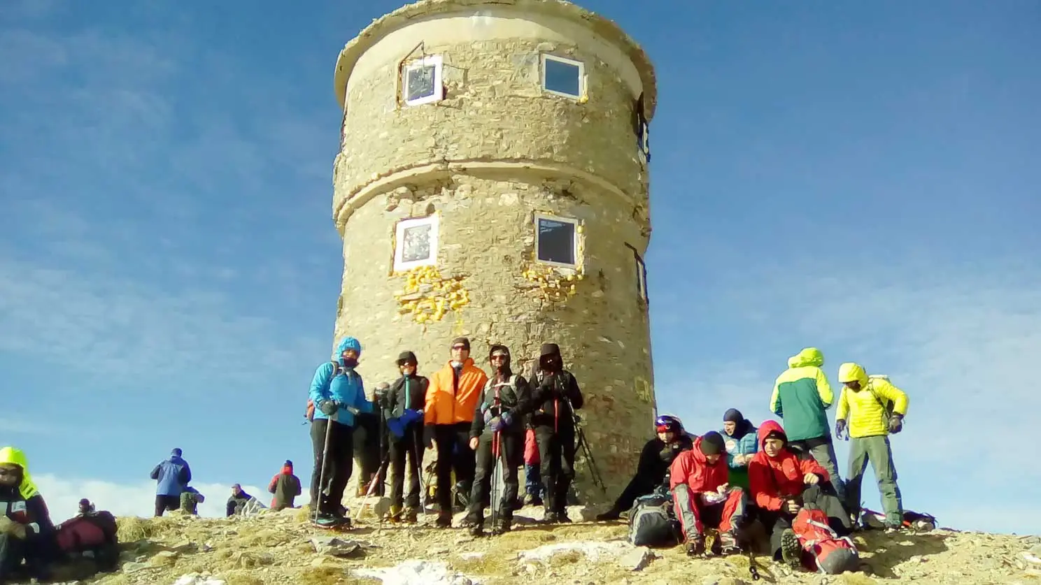 Hiking group by an old stone tower