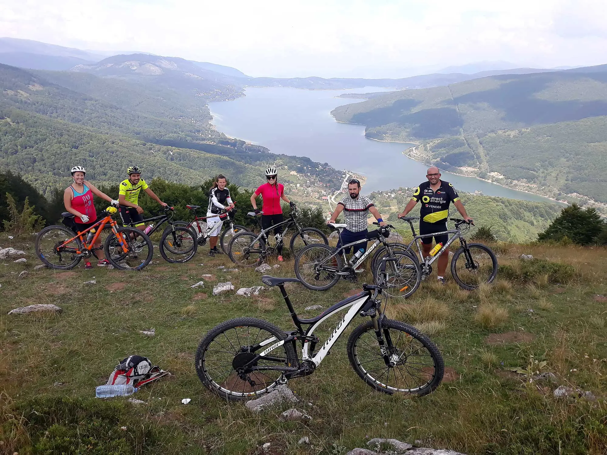 Mountain bike group on a ridge above Lake Mavrovo