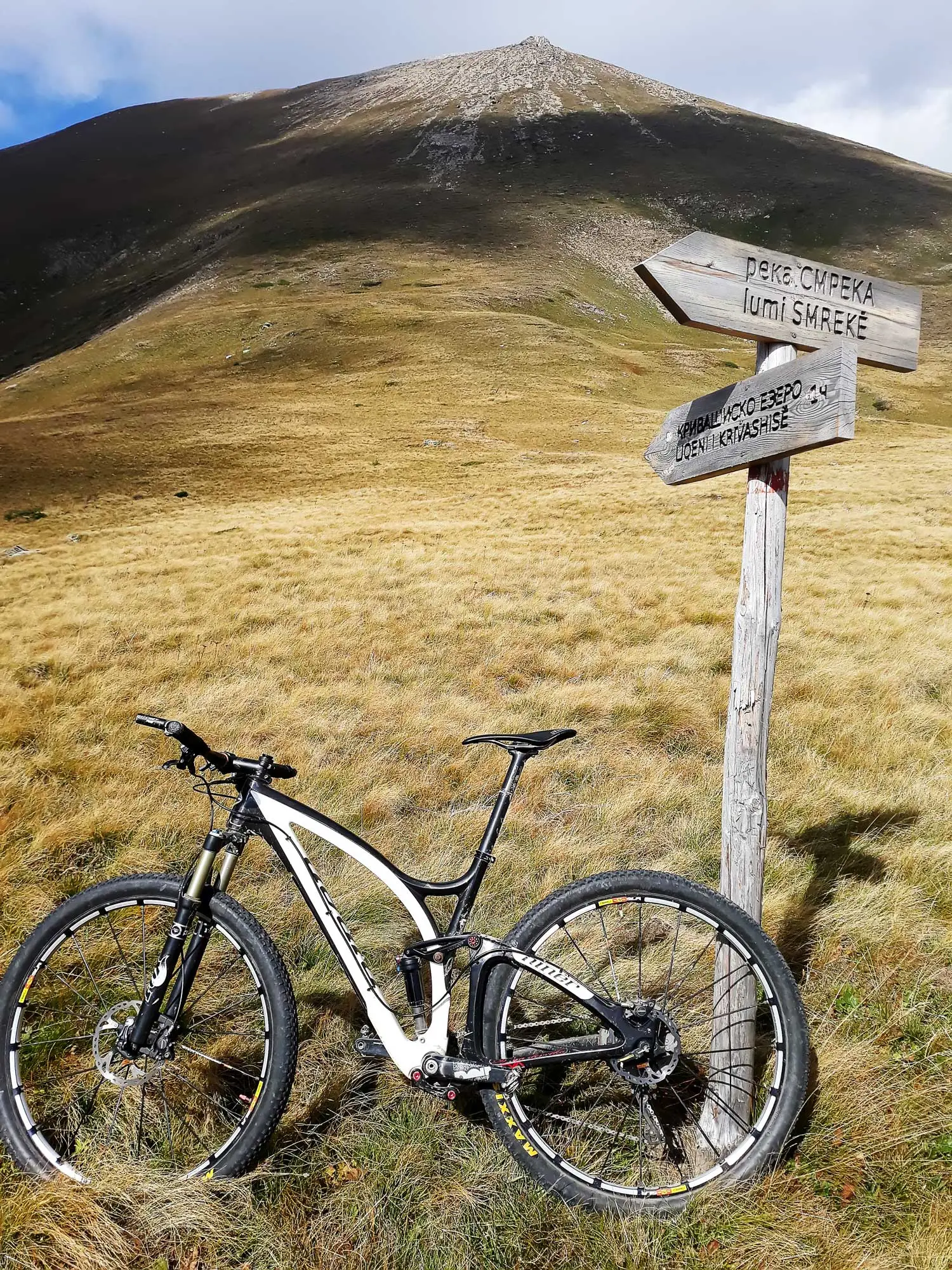 Mountain bike by a trail sign to Krivasko Lake on Shar Mountain