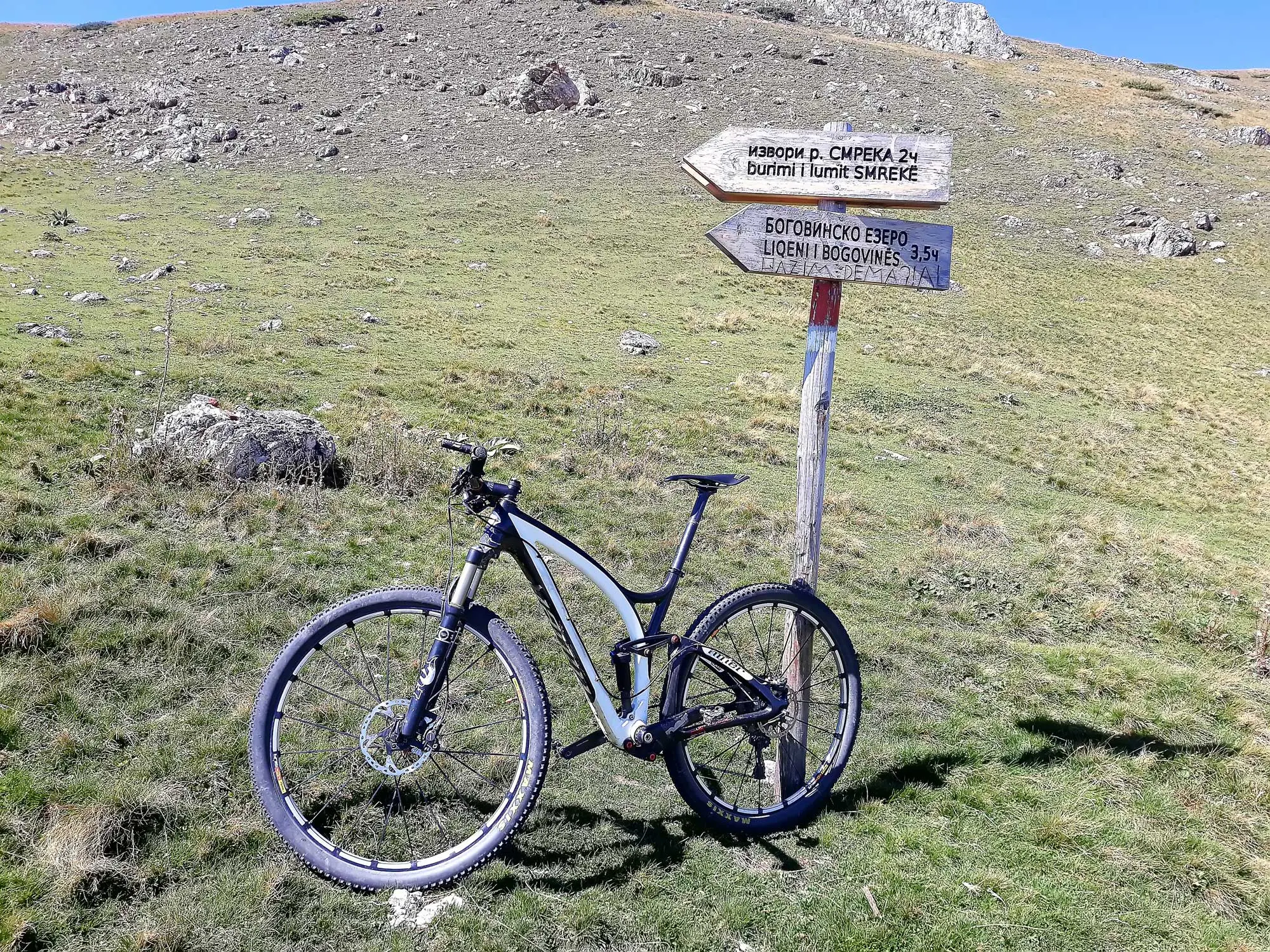 Mountain bike by a trail sign to Bogovinje Lake on Shar Mountain