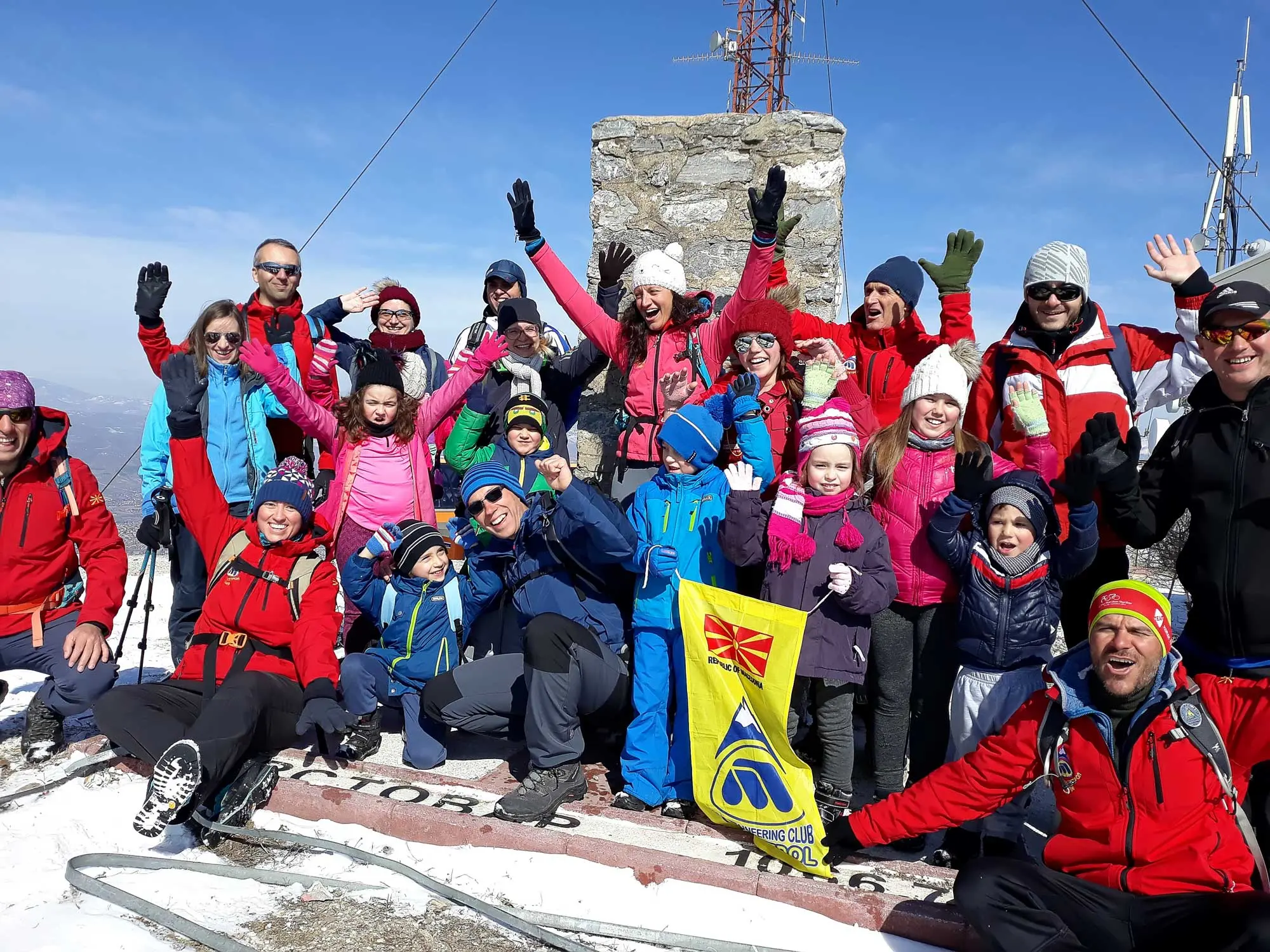 Large group with flags on a summit