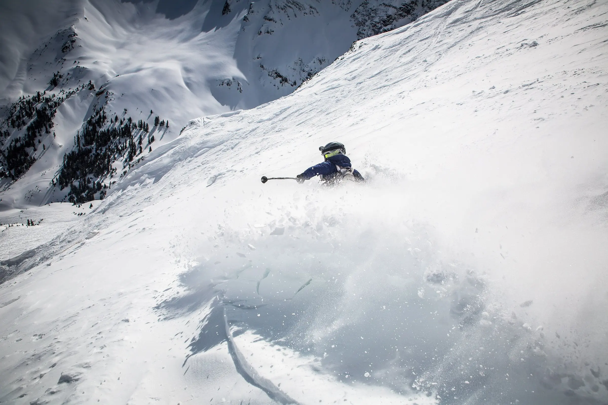 Skier spraying deep powder off the piste