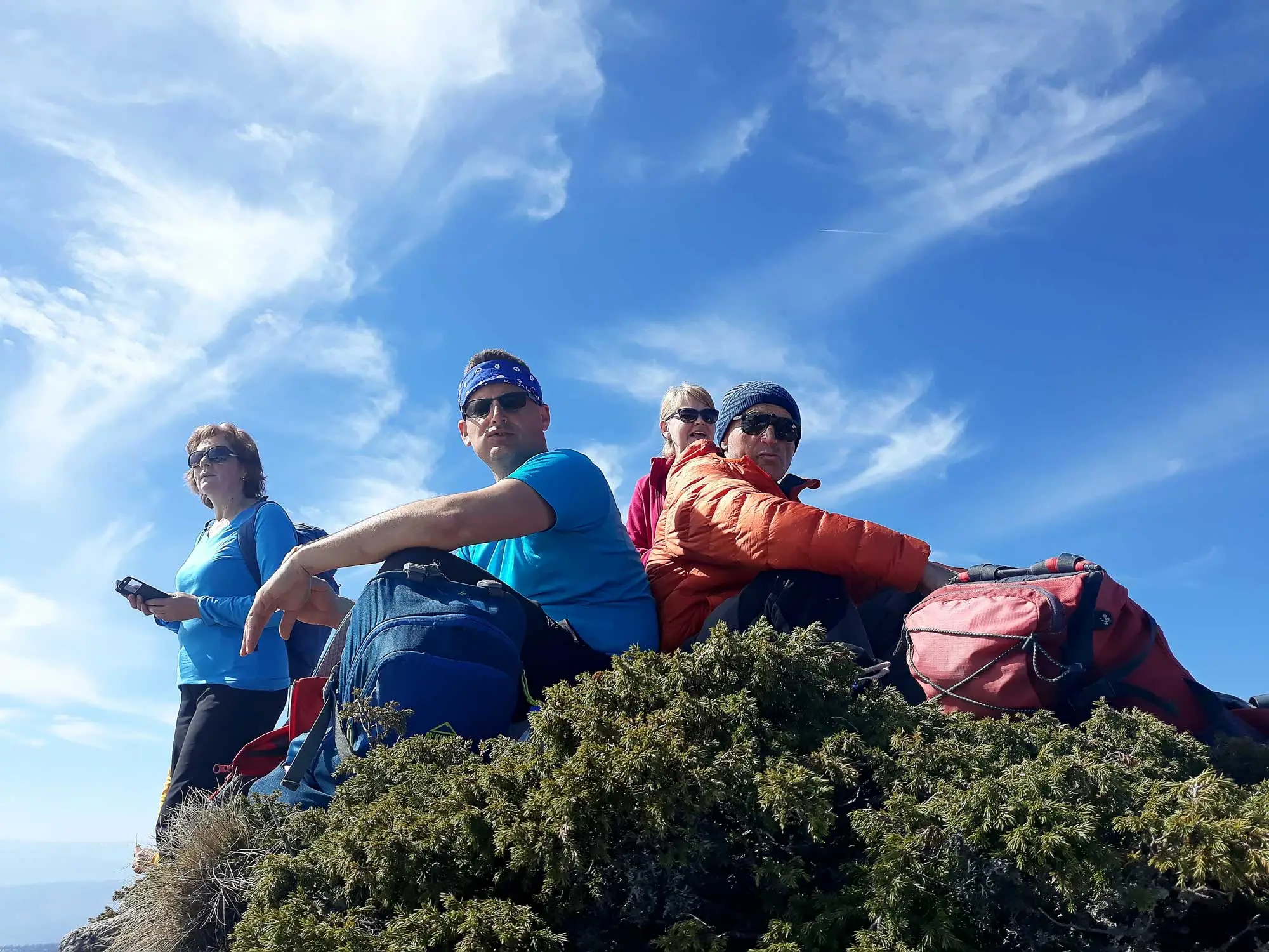 Group of hikers smiling on a summit